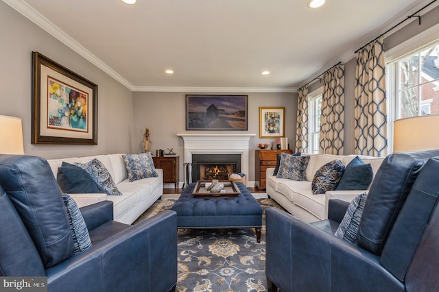 living area with recessed lighting, a warm lit fireplace, and crown molding