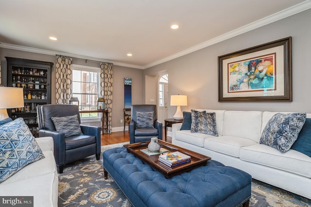 living area with baseboards, ornamental molding, wood finished floors, and recessed lighting