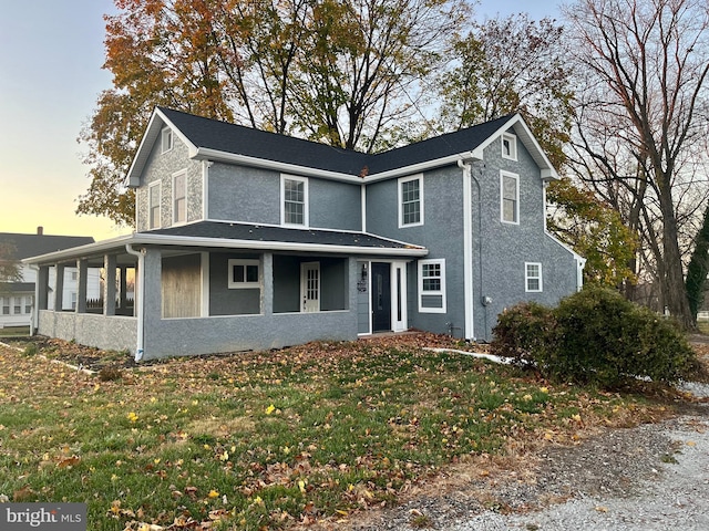 view of front of home with a yard and stucco siding