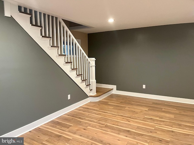 interior space with recessed lighting, wood finished floors, and baseboards