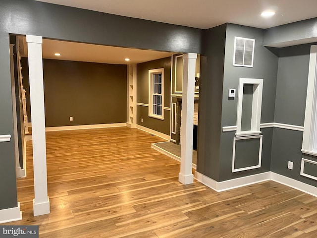 spare room featuring recessed lighting, visible vents, baseboards, and wood finished floors