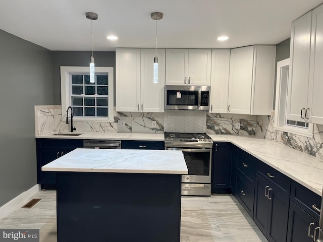 kitchen with visible vents, appliances with stainless steel finishes, white cabinets, and a sink