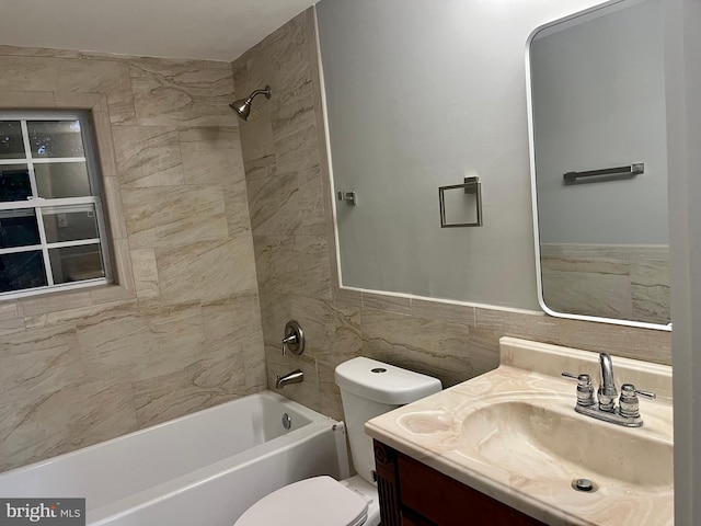 full bathroom with toilet, bathtub / shower combination, tile walls, and vanity