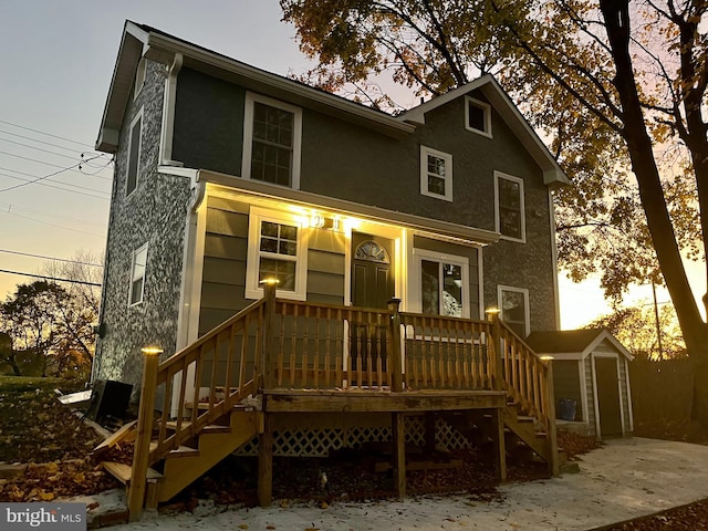 rear view of house featuring covered porch and stairs