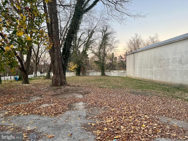 view of yard with a pole building and fence