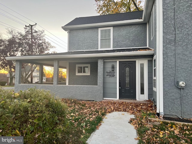 property entrance with stucco siding