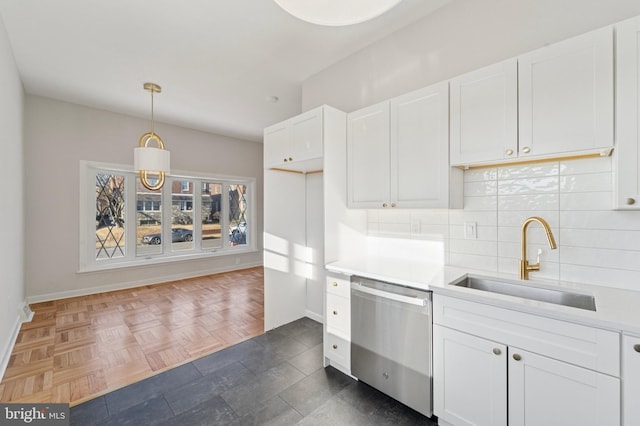 kitchen with a sink, white cabinetry, light countertops, decorative backsplash, and dishwasher