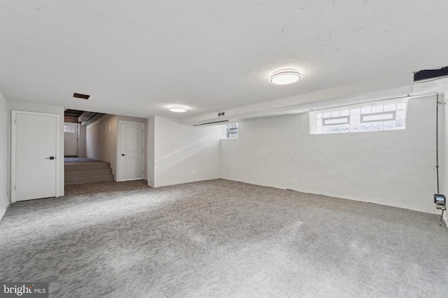 basement with stairway and carpet