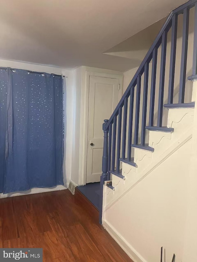 staircase with wood finished floors