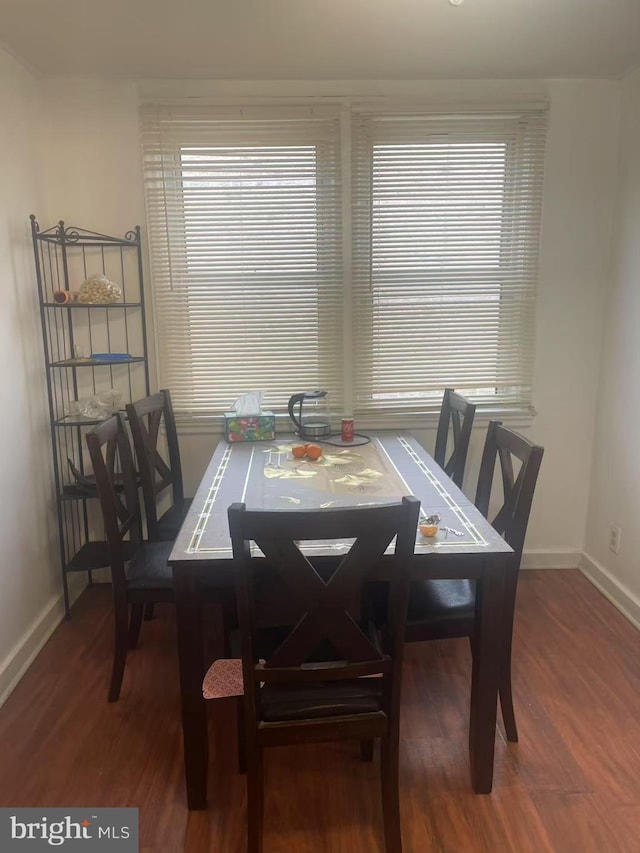 dining area featuring a wealth of natural light, baseboards, and wood finished floors