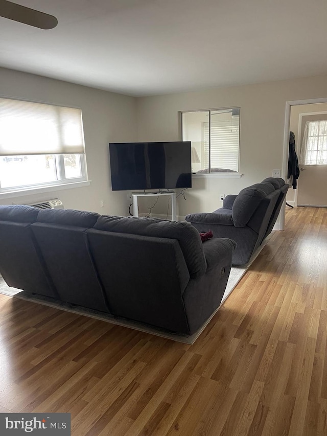 living area with a wealth of natural light and light wood-style flooring