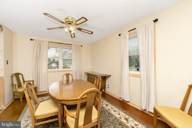 dining space featuring a ceiling fan and wood finished floors