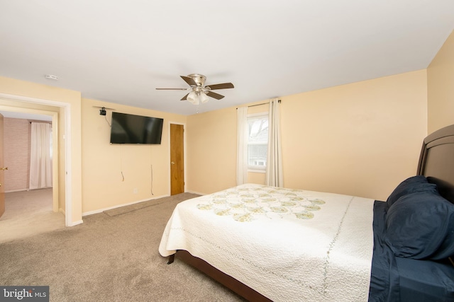 bedroom featuring a ceiling fan, carpet, and baseboards