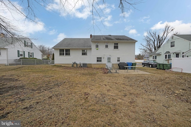 rear view of house featuring central AC, a lawn, and fence