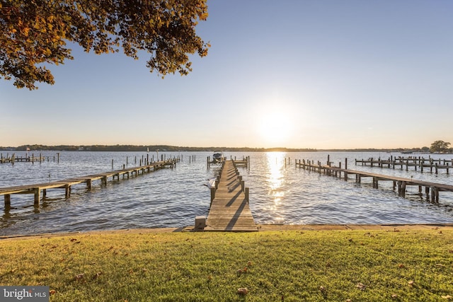 view of dock featuring a yard and a water view