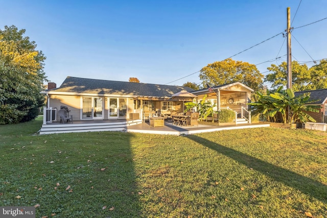 rear view of property with central air condition unit, a chimney, a patio, and a yard