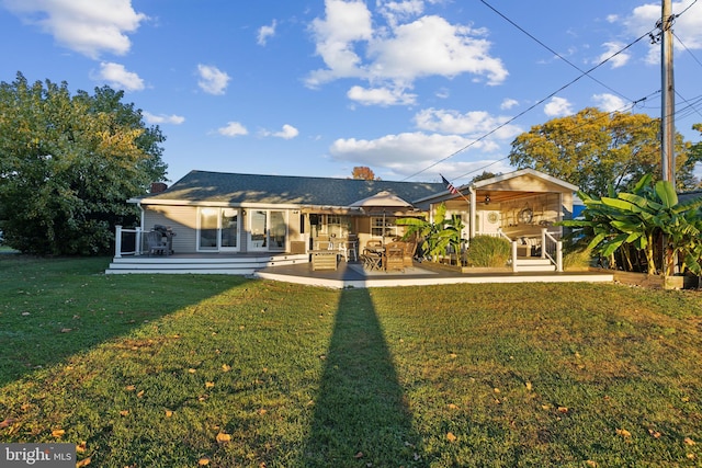 rear view of property with a lawn and a patio