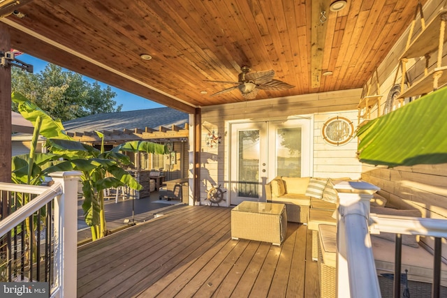 wooden terrace featuring an outdoor living space, a ceiling fan, and french doors