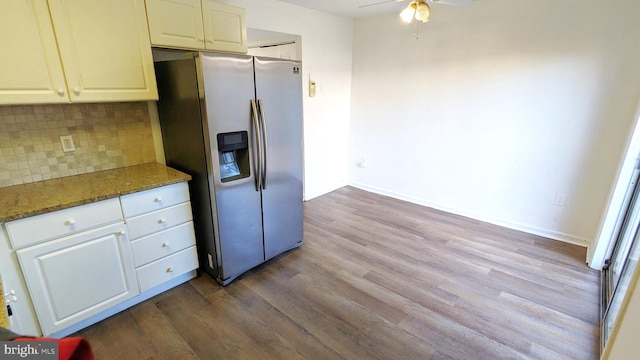 kitchen with stone counters, dark wood finished floors, decorative backsplash, ceiling fan, and stainless steel fridge with ice dispenser