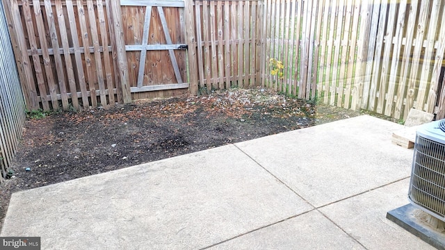 view of patio with central AC unit and fence