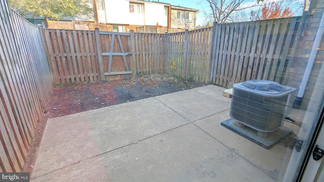 view of patio with a fenced backyard and cooling unit