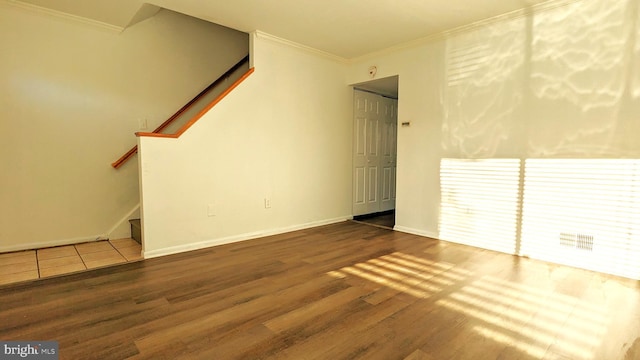 interior space featuring stairs, ornamental molding, and wood finished floors