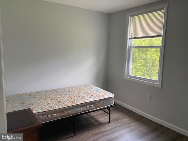 bedroom featuring baseboards and wood finished floors