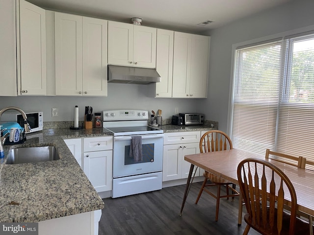 kitchen featuring dark wood-style floors, white cabinets, a sink, white appliances, and under cabinet range hood