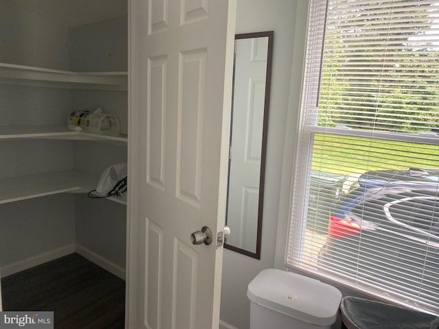 bathroom with toilet and baseboards