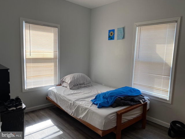 bedroom with baseboards and wood finished floors