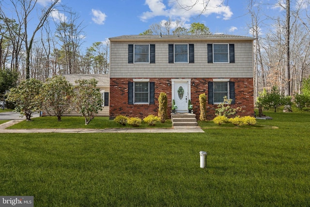 view of front of home with a front yard and brick siding