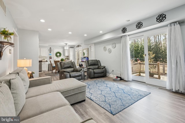 living area featuring a ceiling fan, recessed lighting, and wood finished floors