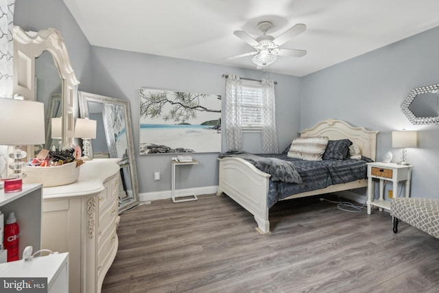 bedroom featuring a ceiling fan, baseboards, and wood finished floors