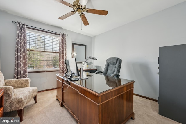 home office with light carpet, ceiling fan, and baseboards