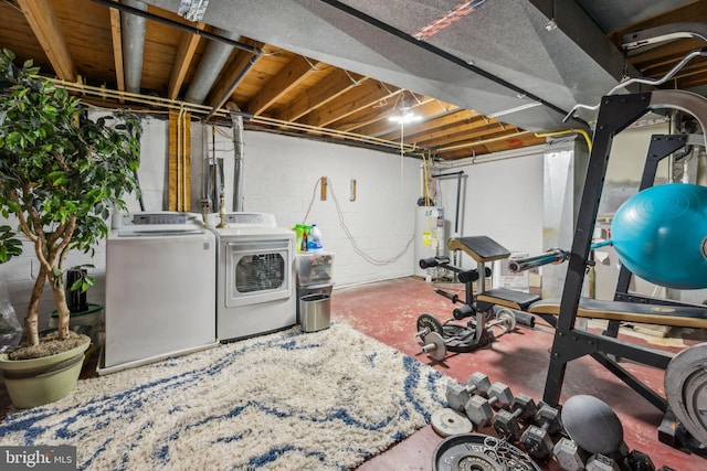 workout room with water heater and separate washer and dryer