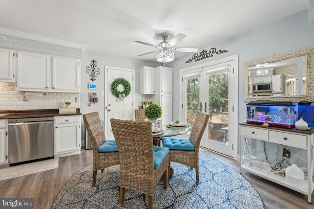 dining space with french doors, ceiling fan, and wood finished floors