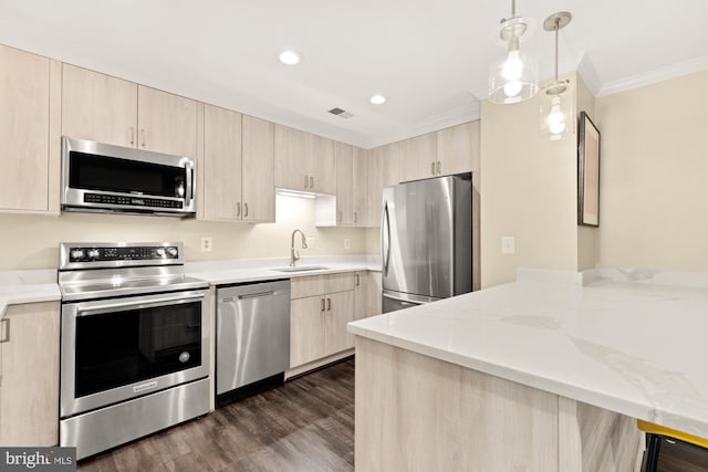 kitchen featuring appliances with stainless steel finishes, a peninsula, and light brown cabinets