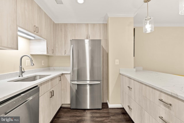 kitchen with ornamental molding, light brown cabinets, appliances with stainless steel finishes, and a sink