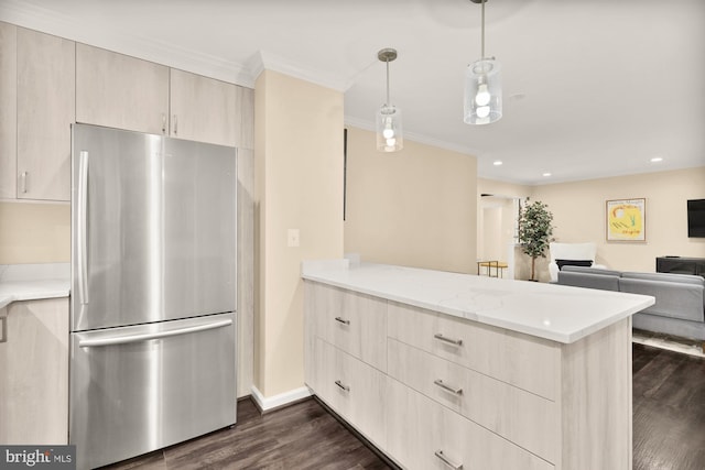 kitchen featuring light brown cabinets, a peninsula, dark wood-style flooring, freestanding refrigerator, and ornamental molding