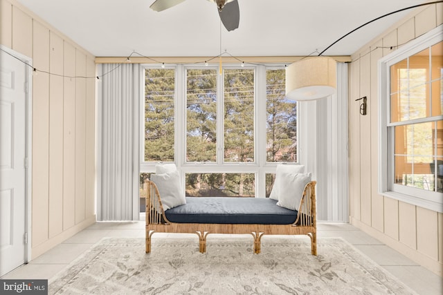 living area with tile patterned flooring and a ceiling fan