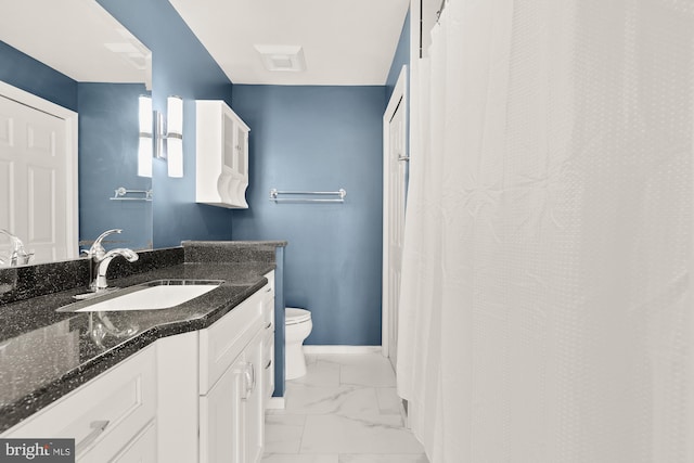 bathroom featuring vanity, toilet, baseboards, and marble finish floor