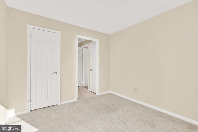 unfurnished bedroom with baseboards and carpet flooring