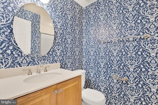 bathroom with toilet and vanity