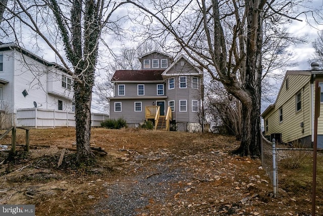 view of front of home featuring fence