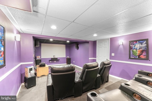 home theater room with a drop ceiling, recessed lighting, and baseboards