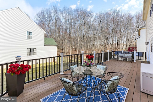 wooden terrace featuring outdoor dining space