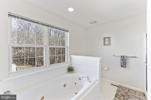 bathroom with a tub with jets, visible vents, baseboards, and recessed lighting