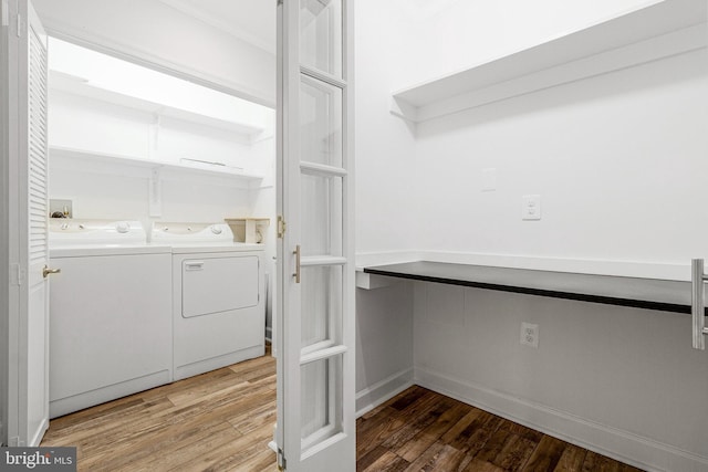 washroom featuring light wood-type flooring, laundry area, and washing machine and clothes dryer