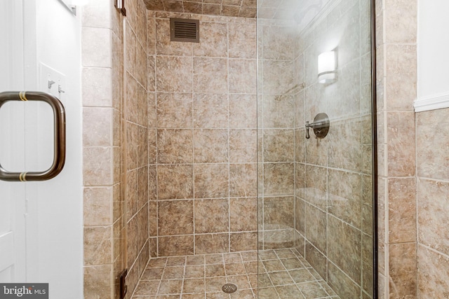 bathroom with a stall shower and visible vents