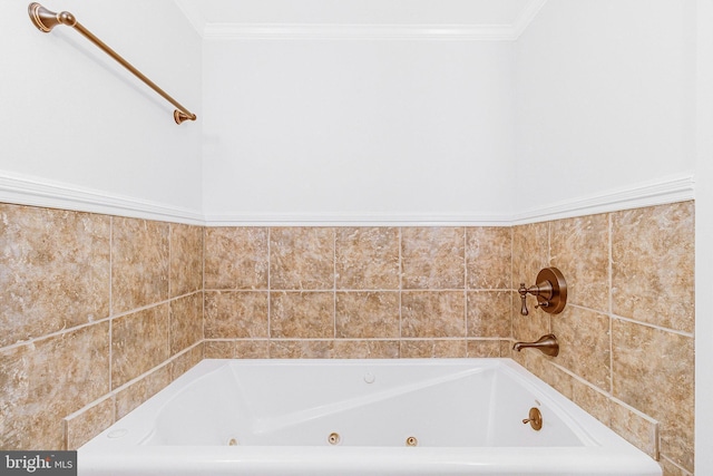 full bathroom with crown molding and a tub with jets